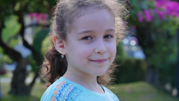 Portrait Cute Beautiful Little Girl or Child Smilling on the Sunset in City Park . Stock Footage