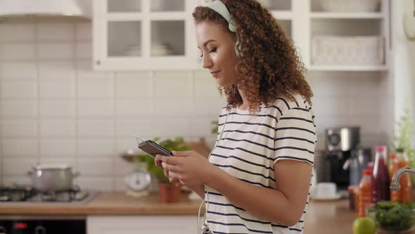 Woman listening to music in the kitchen