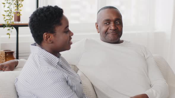 Family Conversation at Home Afro American Couple Husband and Wife Talking Sitting on Sofa Black