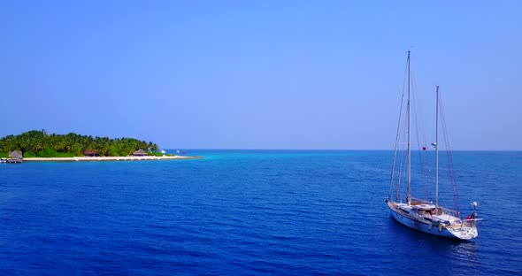 Wide angle drone copy space shot of a white sand paradise beach and aqua blue water background