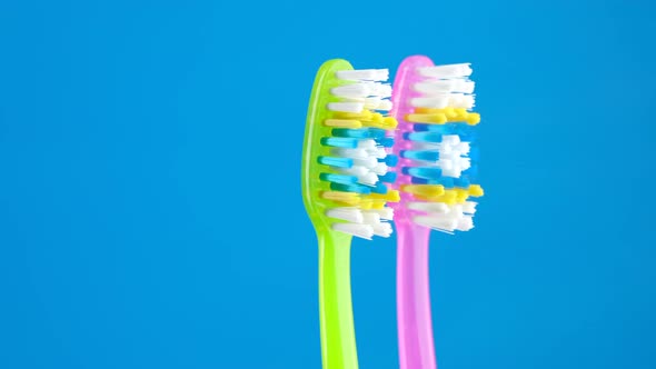 Toothbrush green and pink on blue background. oral hygiene