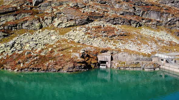 Tranquil Blue Waters Of Weisssee Lake And Gravity Dam With Rocky Mountain In Salzburg, Austria. - ae