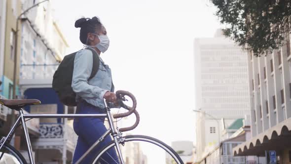 Woman wearing medical coronavirus mask walking on the street