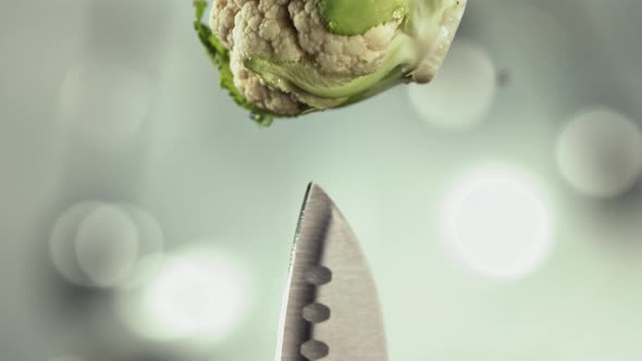 Fresh Cauliflower Falling Down on Knife Stuck