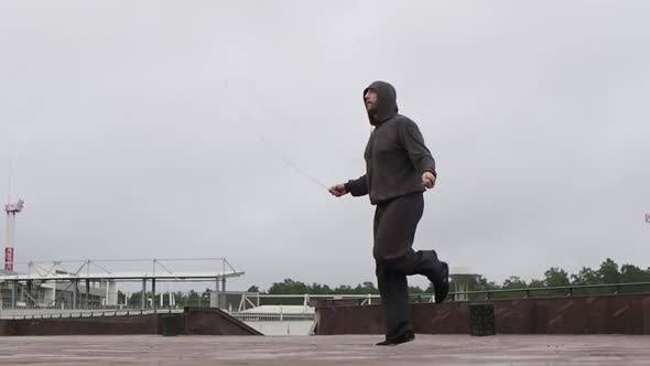 A Rope Jumping. A Man Does Exercises for Weight Loss.