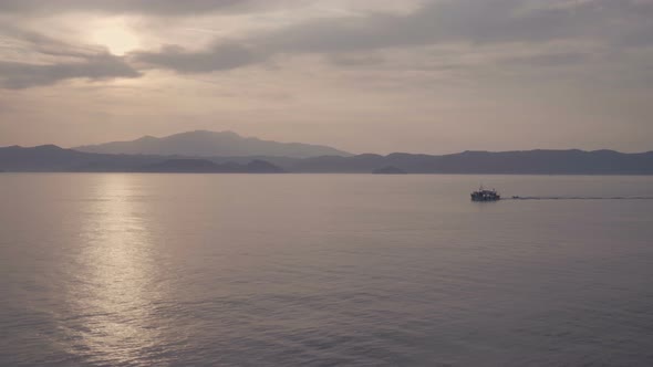 Scenic Landscape of Cruise Ship Slowly Sailing Through Calm Sea with Cloudy Sky in Limnos, Greece