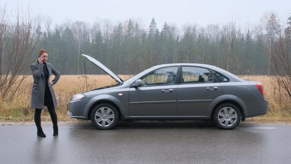 Young Woman on Countryside Road Trying To Get Help with Her Broken Down Car and Call Evacuation