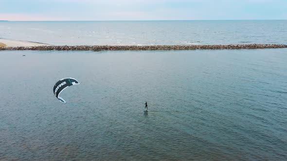 Aerial Drone View of a Corekites Kitesurfers Hydrofoiling  in Engure Port at in Baltic Sea