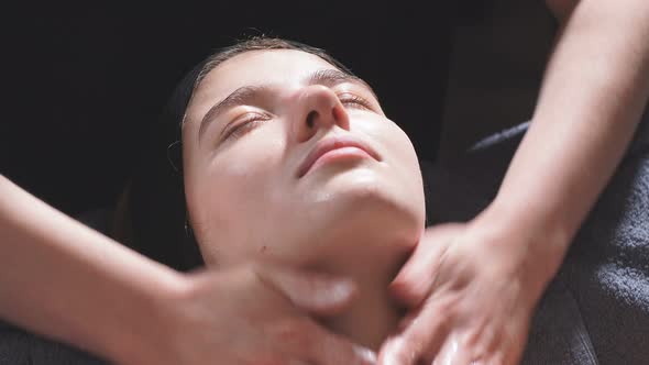 Young Women at the Spa Enjoy Facial and Cleavage Treatments