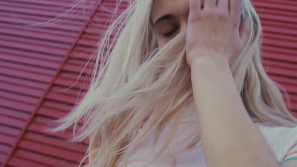 Woman grunge standing at a colorful wall