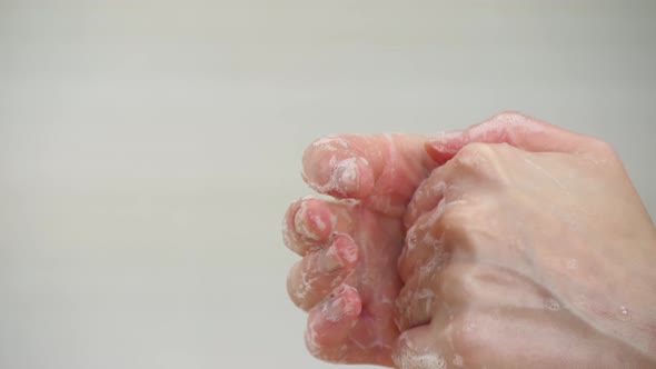 Close - Up of Hands. A Woman Washes Her Hands. Soap Bubbles and Foam. Concept of Hygiene, Control