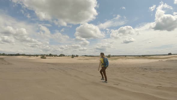 Young Girl Hiking in Dunes. Slow Motion.