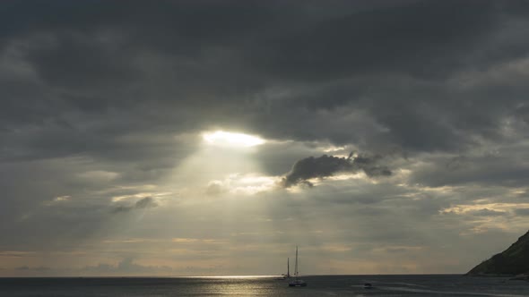 Yachts on the Background of Sunset and Dark Clouds