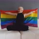 Lesbian having fun and waving LGBT flag at home while sitting on white sofa - VideoHive Item for Sale