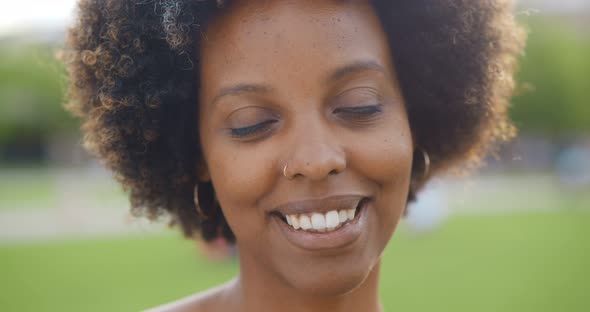 Bokeh Portrait of Young Beautiful African Woman in Summer Park