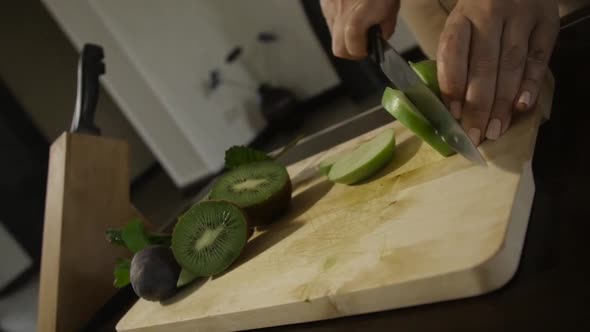 Woman Cutting Apple on the Table
