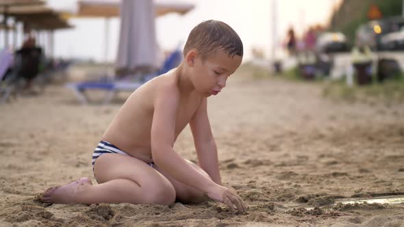 Kid Playing with Sand the at Beach During Summer Vacation