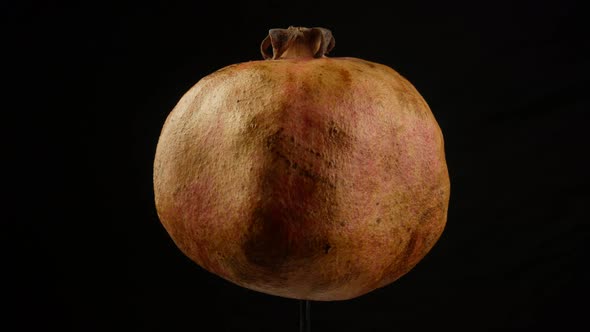 Pomegranate on black background