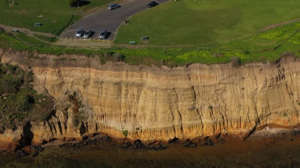 AERIAL TILT UP Revealing Coastal Township With Limestone Cliff Faces