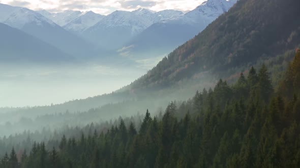 Charming Morning Fog Over the Valleys of the Alpine Mountains.