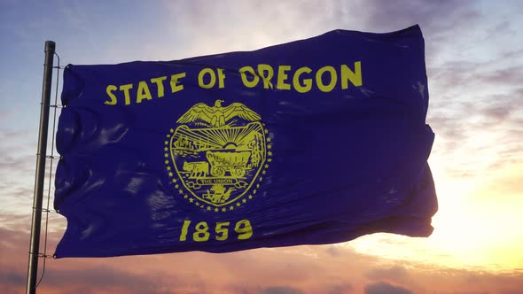 Flag of Oregon Waving in the Wind Against Deep Beautiful Sky at Sunset