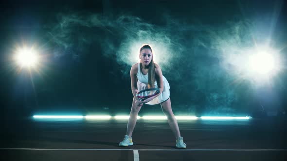 A Woman with a Tennis Racket in Her Hands is Ready to Play