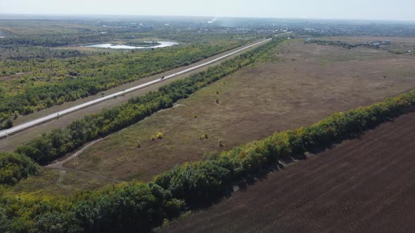 a Highway Stretching to the Horizon Among Agricultural Fields