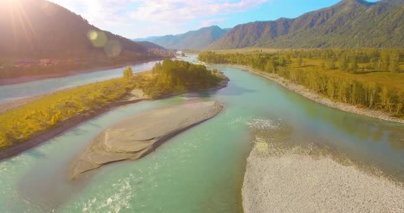 Low Altitude Flight Over Fresh Fast Mountain River with Rocks at Sunny Summer Morning