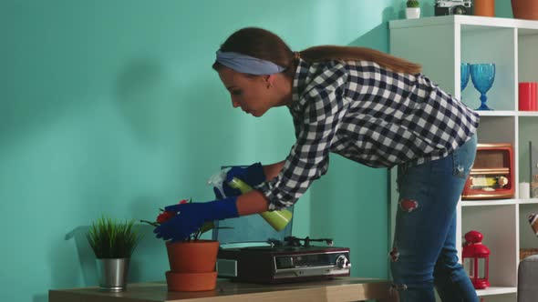 Woman Is Spraying Water On Plants at Home