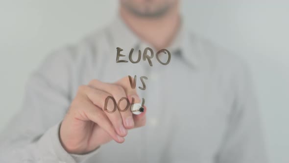 Euro Vs Dollar Writing on Screen with Hand