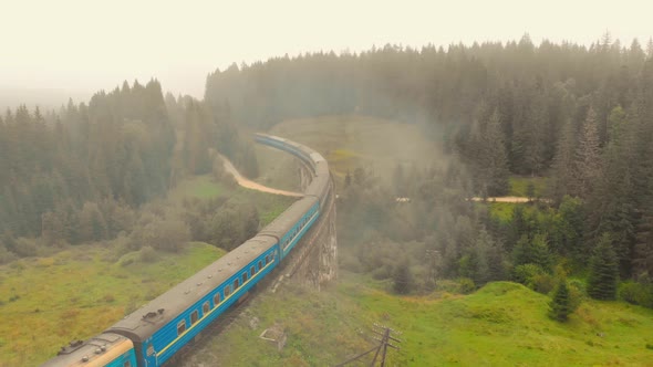 Train Moving in the Carpathian Mountains in Fog