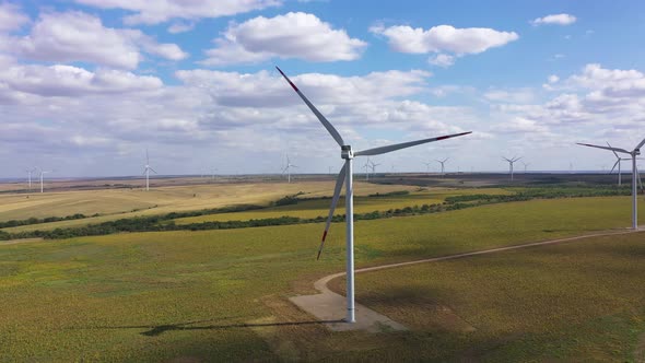 Aerial View Over the Farm Landscape and Wind Turbines Generating Clean Renewable Energy