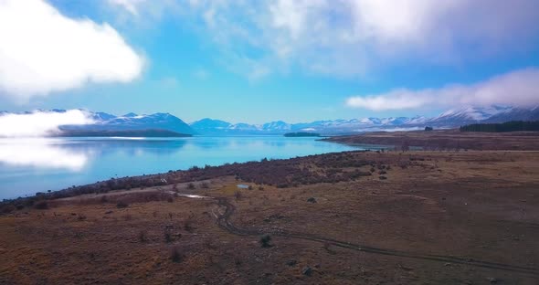 Aerial shot of Calming and relaxing Tekapo Lake in New Zealand. Epic cinematic aerial shot of flying