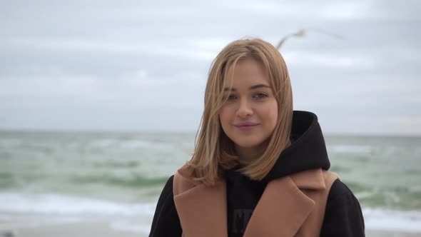 Portrait of Young Woman Spending Weekend Near Seaside Posing on Camera Smiling Being in Good Mood