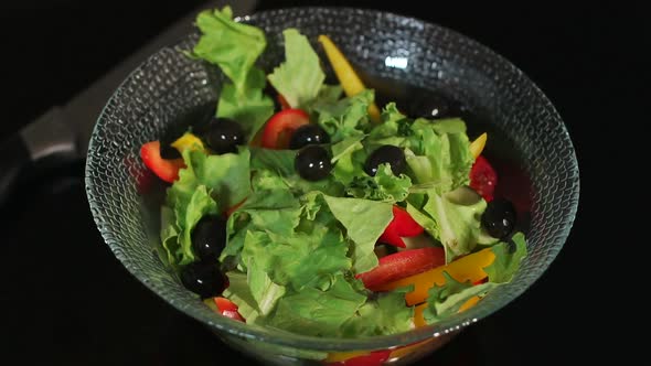 Girl Prepares a Salad of Vegetables and Black Olives, Close-up.