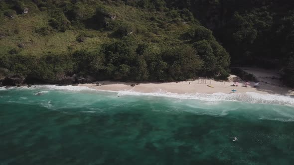 Aerial View of Tropical Beach with Azure Blue Water and Foaming Ocean Waves