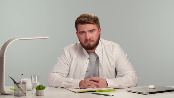 Bearded Positive Man Looks at Camera Listens Carefully Information Shows Gesture you are Right 