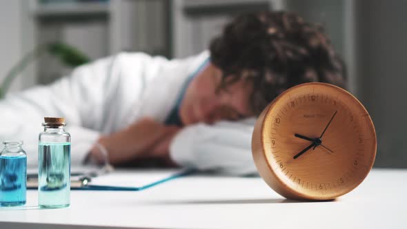 Doctor Medic Nutritionist Tired Sleeping At Workplace In The Foreground The Clock Is A Girl Sleeping