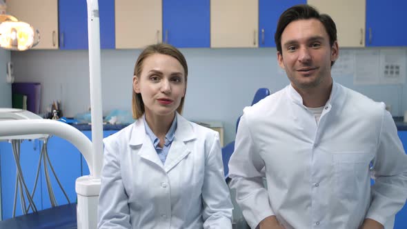 Dental Doctors Talking Then Smiling at Camera