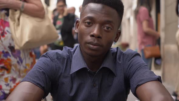 Handsome black african man staring at camera in the street- slow motion