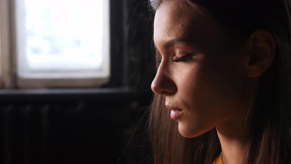 Beautiful Girl in a Yellow Sportswear is Doing in Yoga Breathing Correctly