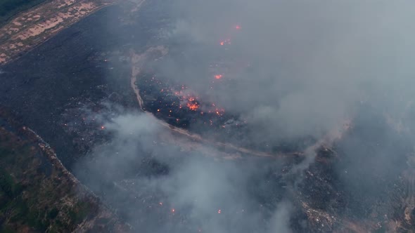 Rubbish junkyard on fire. Air pollution