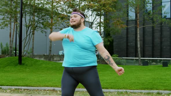 Handsome Obese Guy Jumping in Front of the Camera