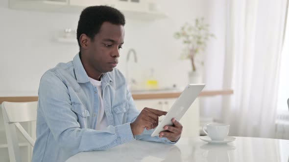 African Man Using Tablet at Home