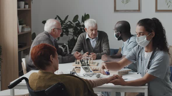 Medical Workers Taking Care of Elderly People at Nursing Home