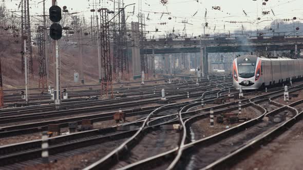 High Speed Passenger Train in Motion at Railway Station at Sunset in Europe