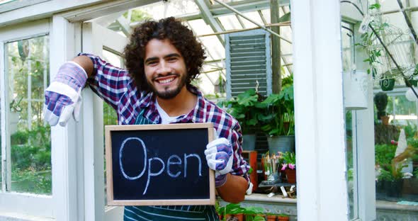 Happy man holding open sign