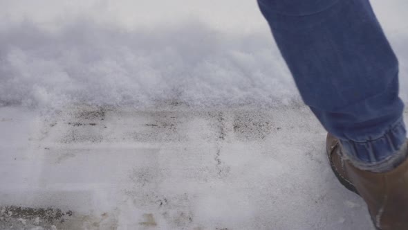 Clearing snow with a snow shovel close-up.