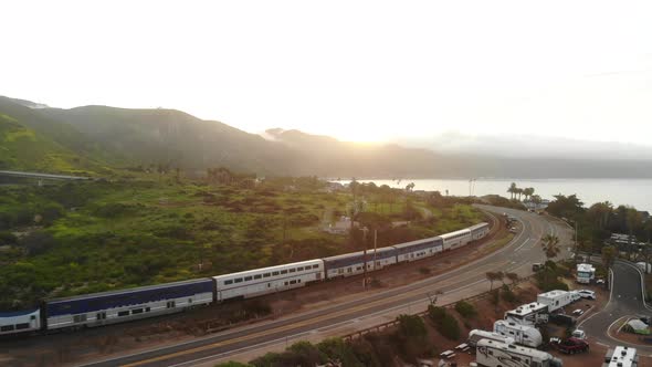 A passenger train traveling down the Ventura, California coast line along the pacific ocean beaches