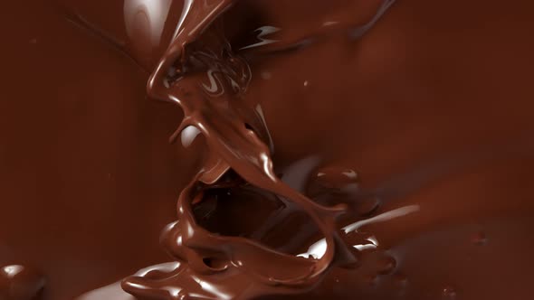 Super Slow Motion Shot of Splashing Melted Chocolate Background 